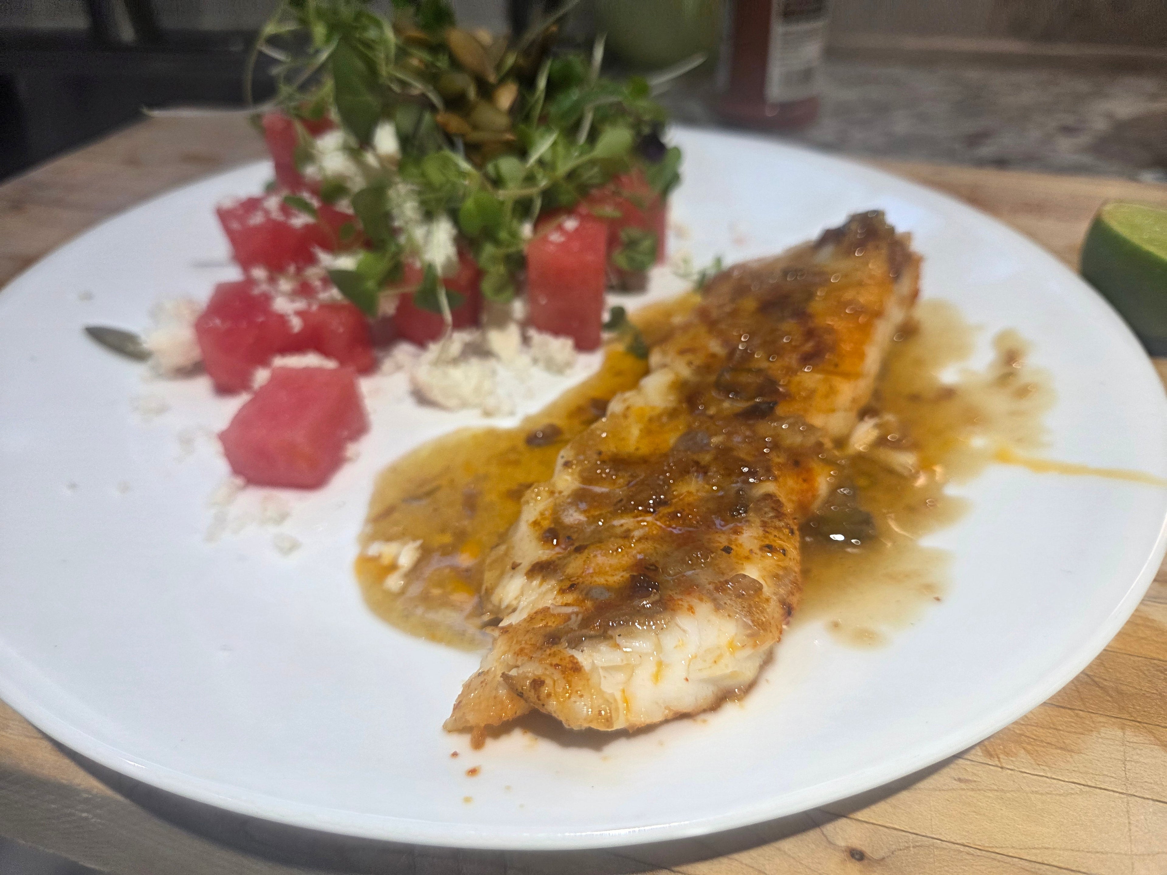 Pan fried redfish with lime glaze and watermelon salad