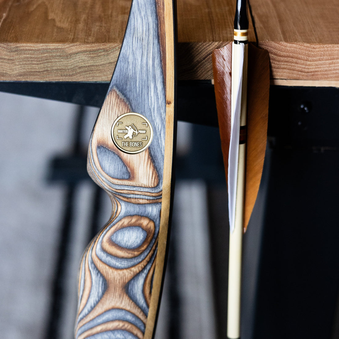 A traditional longbow at full draw in golden evening light