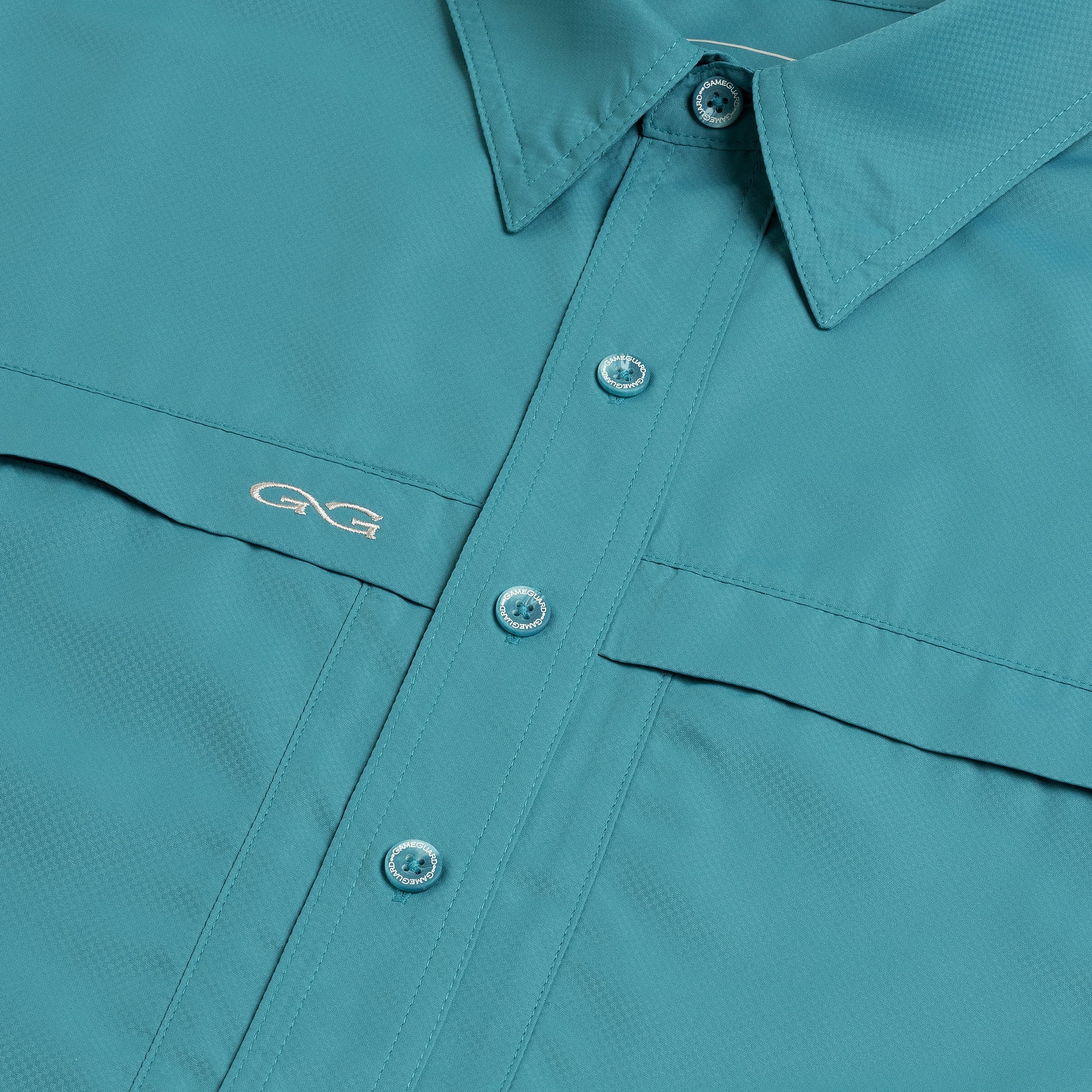 Teal GameGuard hunting shirt with button front, chest pocket, and embroidered GG logo for outdoor adventures