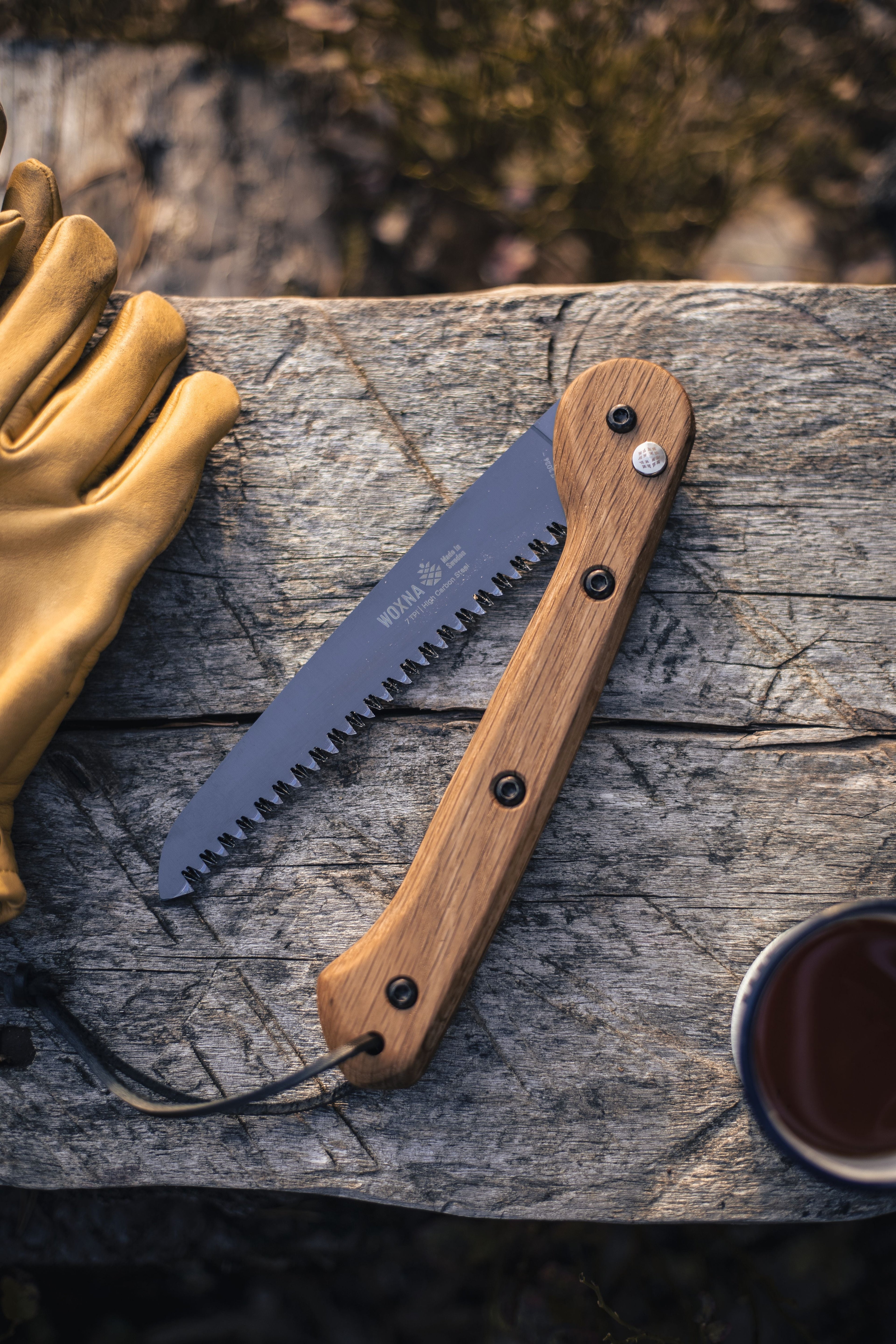 Wood-handled folding saw with serrated blade for outdoor hunting and camping use
