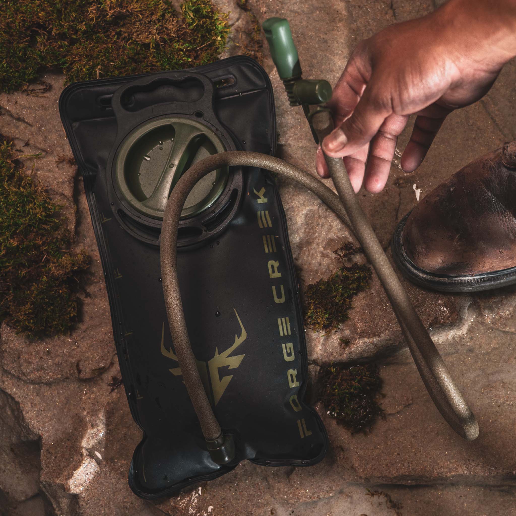 Forge Creek hydration bladder with hose, ideal for hunting and outdoor adventures on rocky terrain