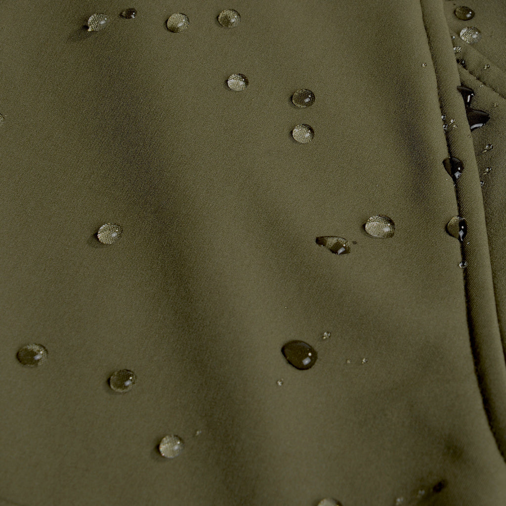 Olive green waterproof hunting jacket fabric with beaded water droplets, ideal for outdoor gear and wet weather.