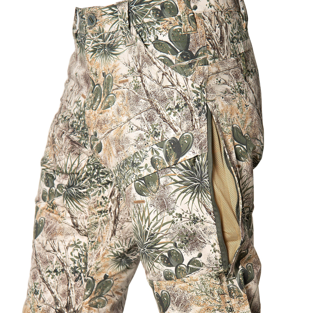 Desert camo hunting pants with cactus print, mesh lining, and GameGuard branding for outdoor use