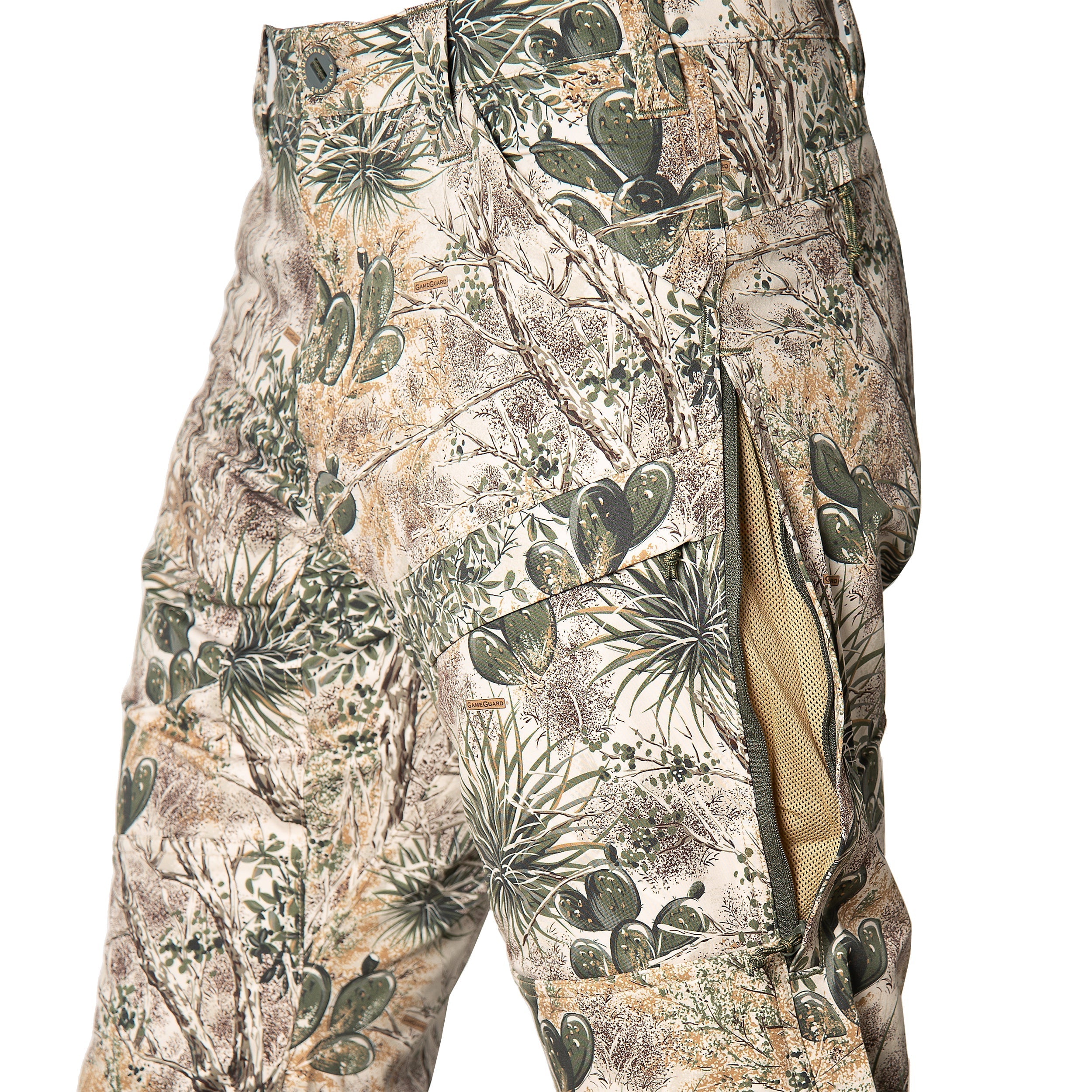 Desert camo hunting pants with cactus print, mesh lining, and GameGuard branding for outdoor use