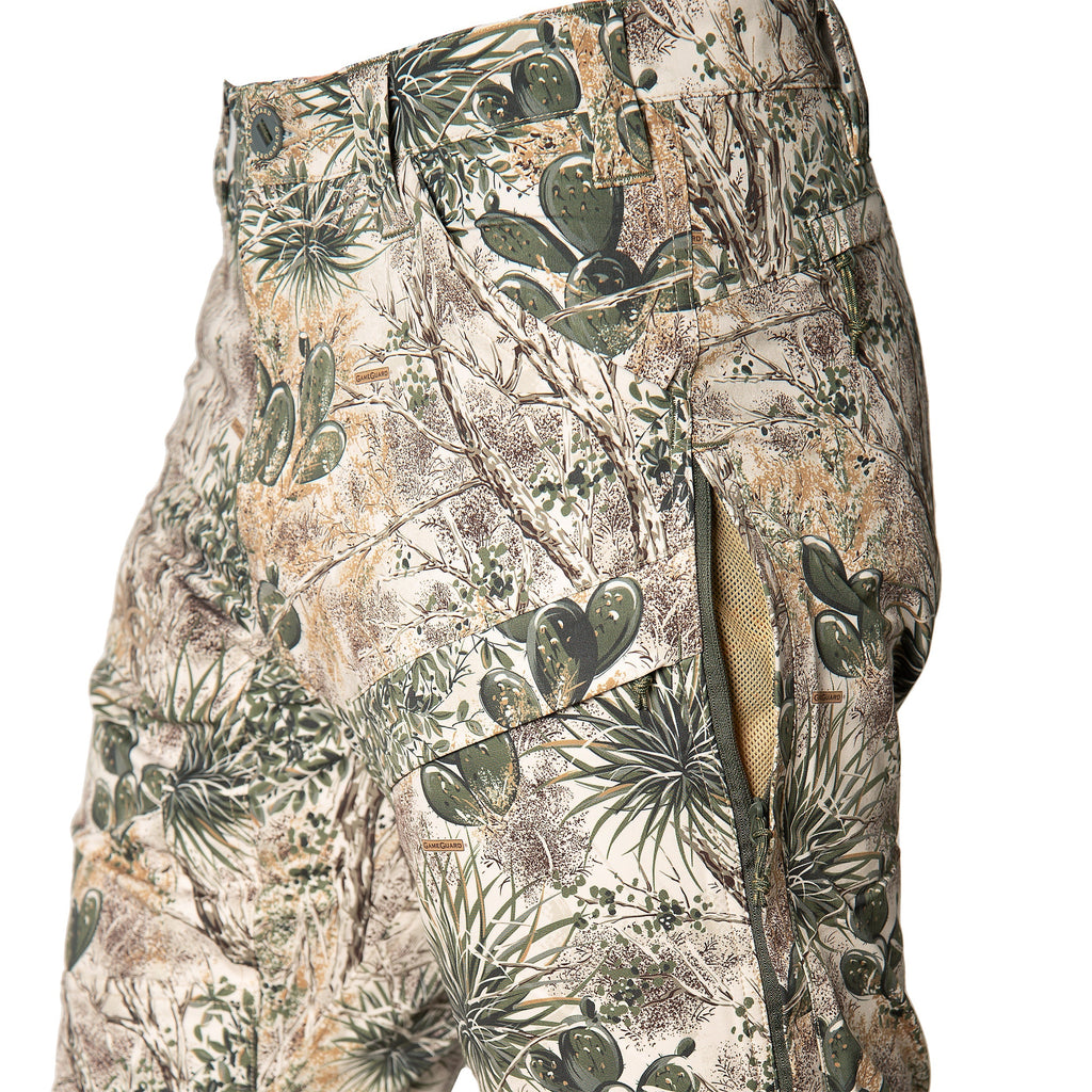 GameGuard desert camo hunting pants with cactus print, zippered pockets, and durable fabric for outdoor use