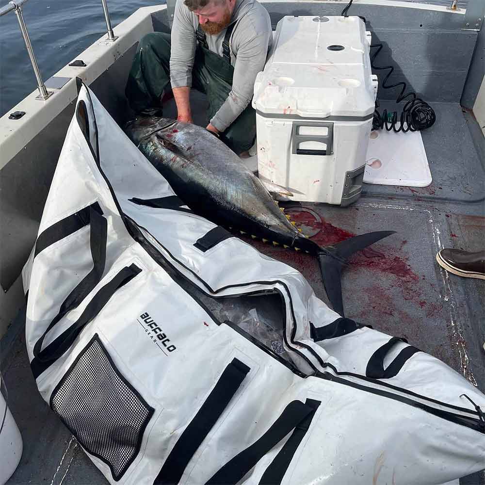 Buffalo Gear white fish bag holding large tuna on boat, ideal for fishing gear and catch storage