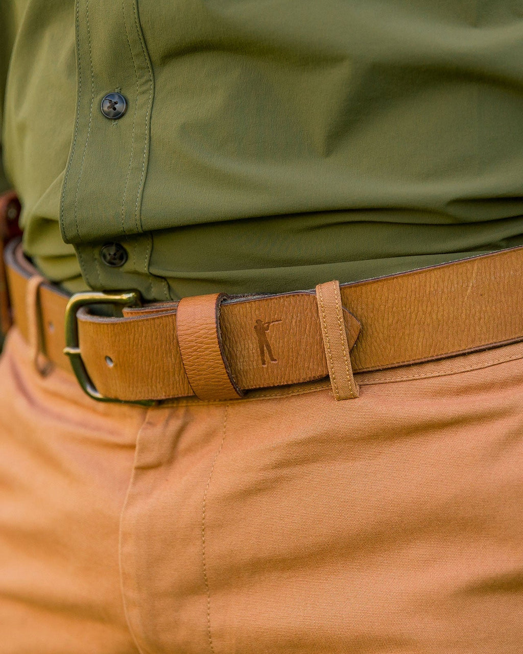 Ball and Buck Signature Leather belt worn with a green shirt and khaki pants