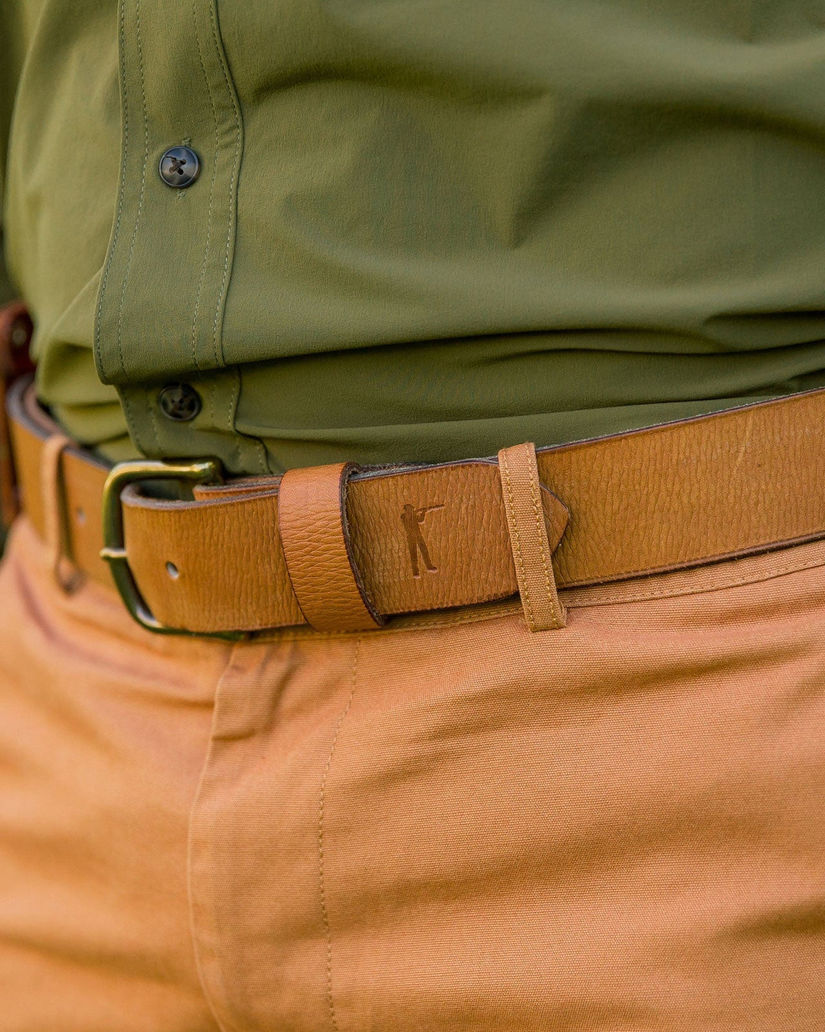 Ball and Buck Signature Leather belt worn with a green shirt and khaki pants