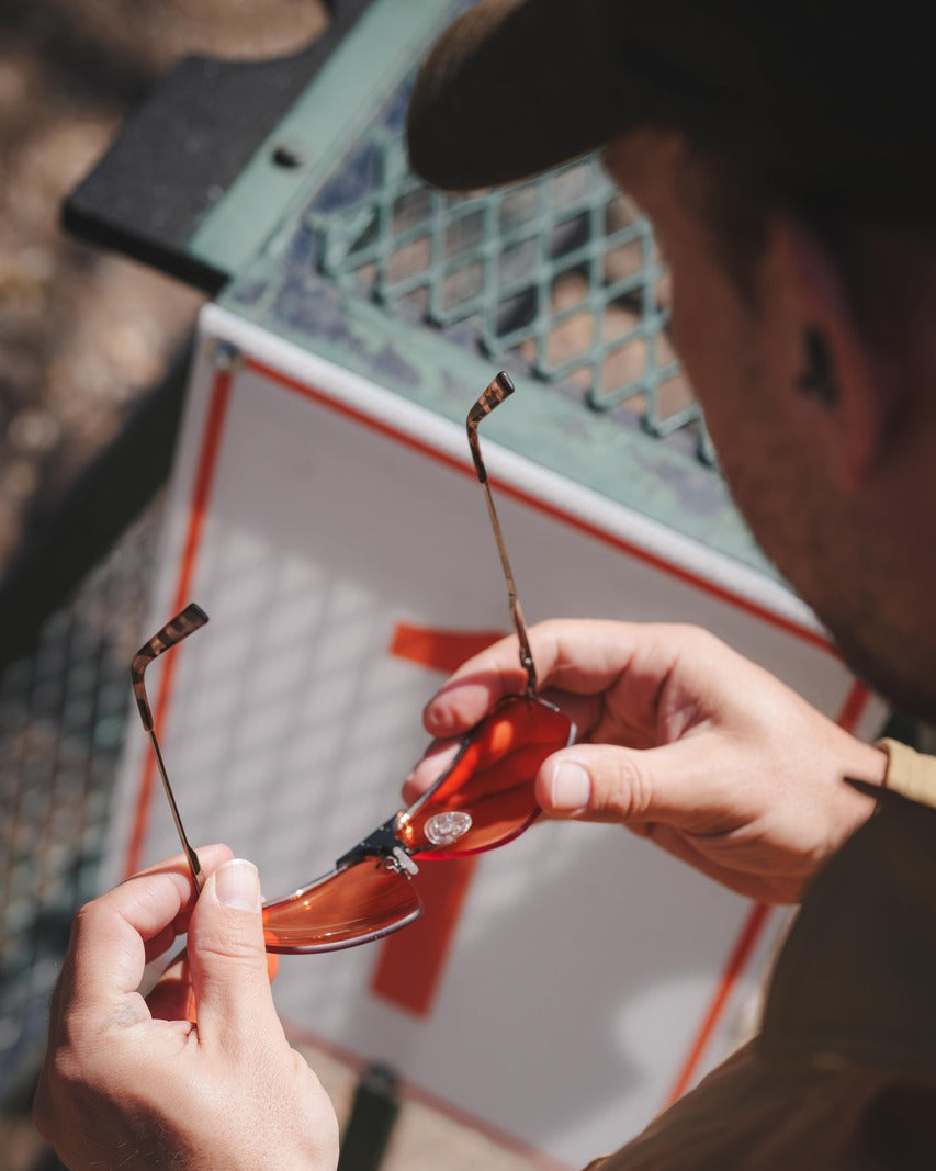 Hands unboxing the Ranger x Ball and Buck Edge shooting glasses from the co-branded box