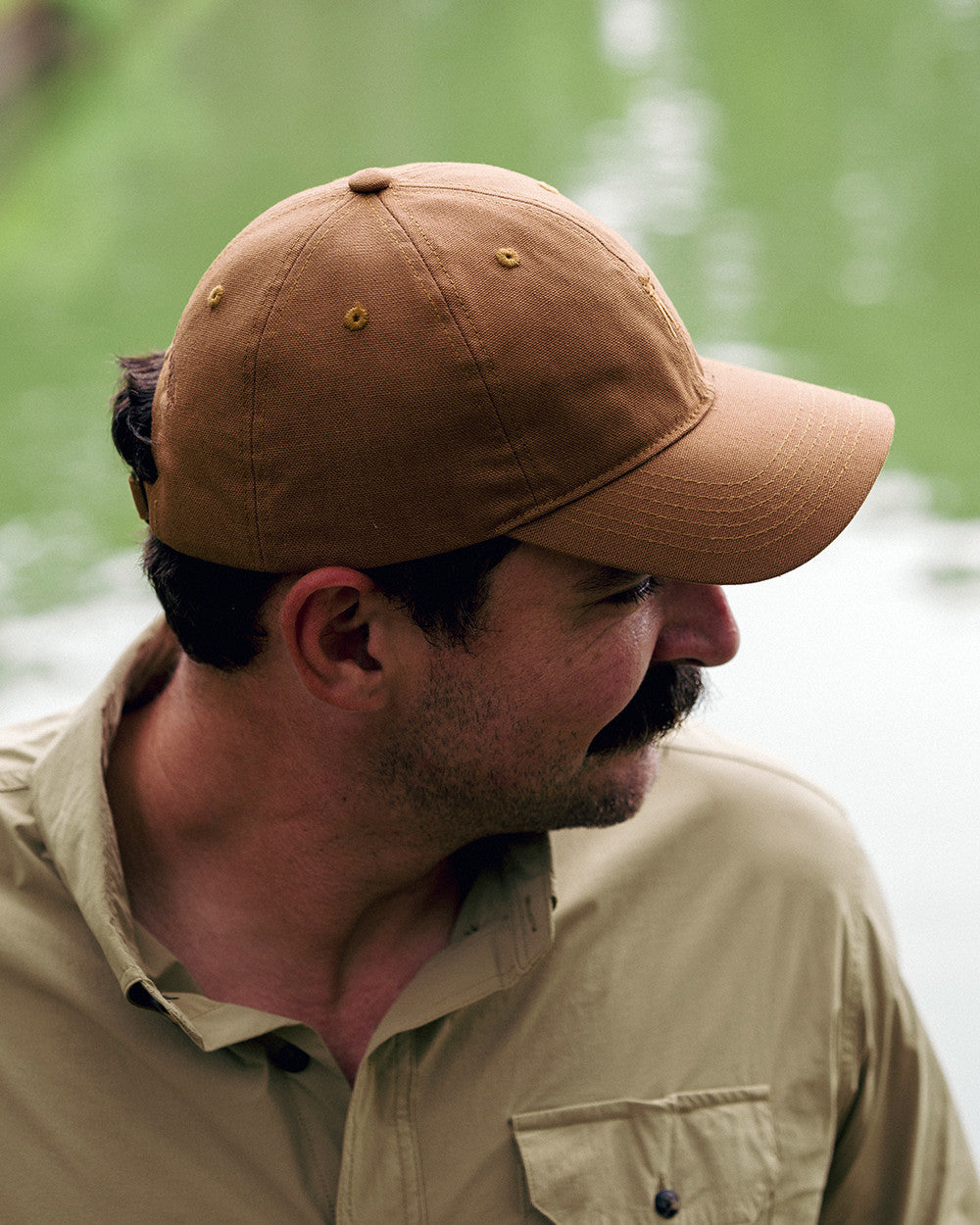Man wearing the Golden Wheat Arthur Core Hat with a khaki shirt, profile view