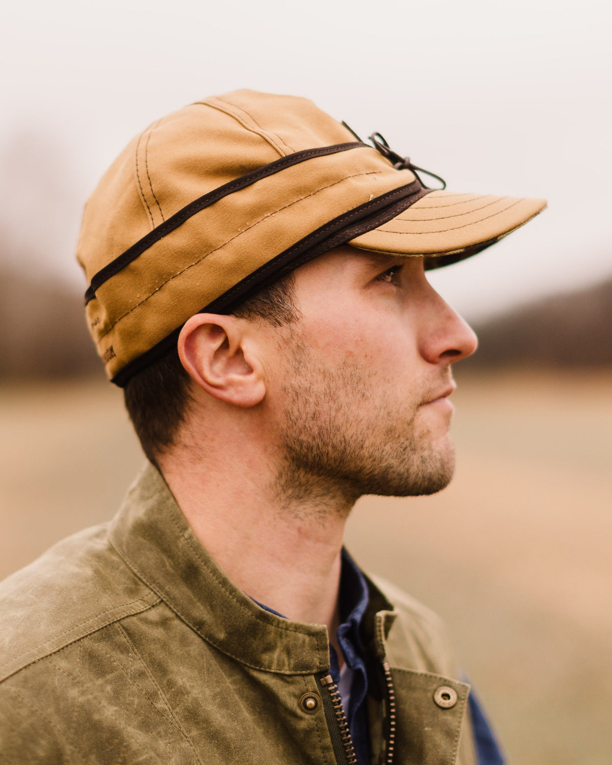 Man in profile wearing the Stormy Kromer x Ball and Buck cap in Signature Canvas