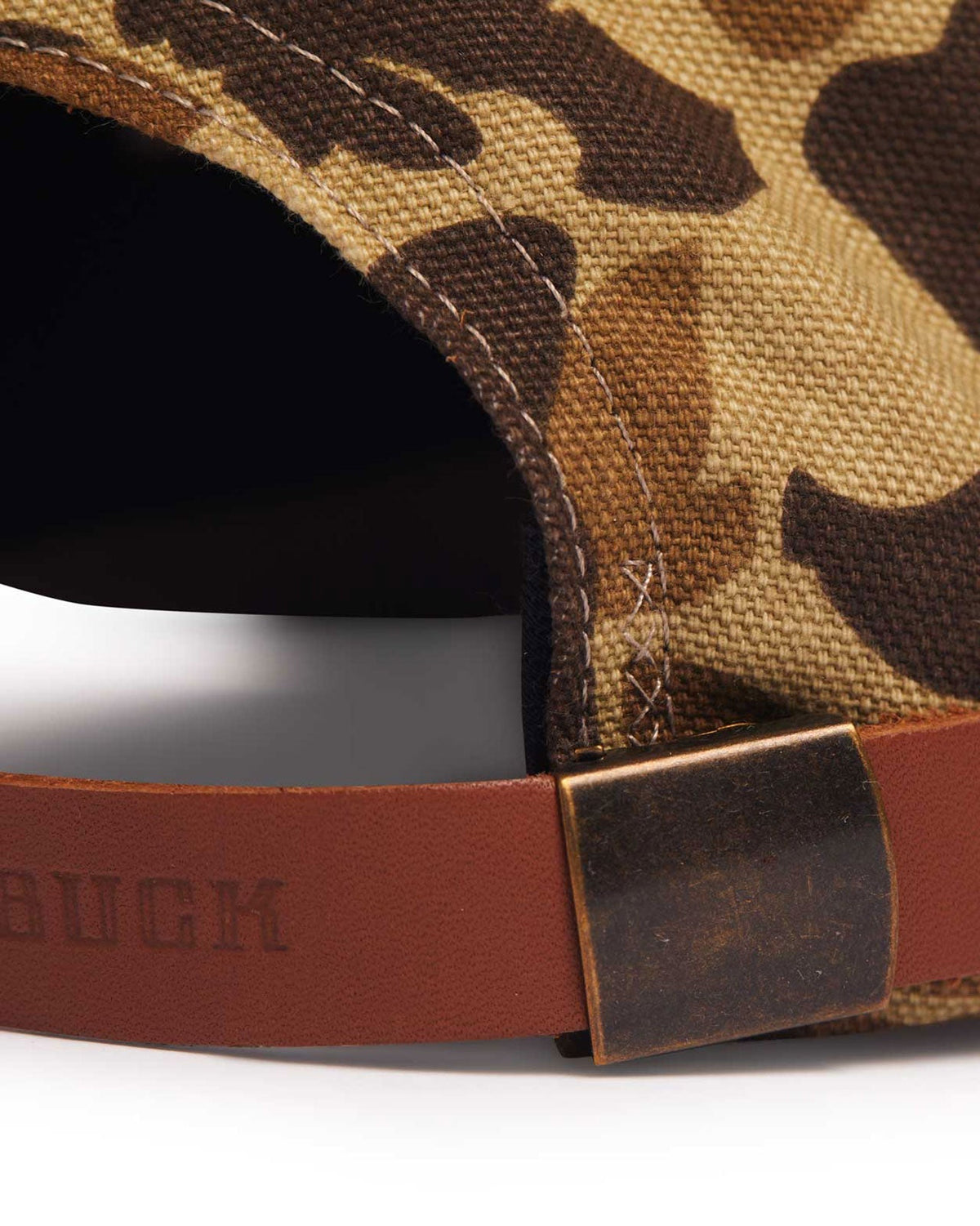 Adjustable leather strap with antique brass clasp on the Arthur Field Hat