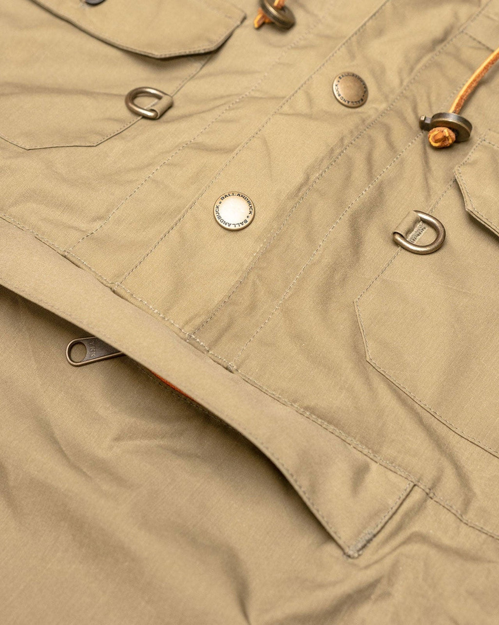 Brass snaps and D-rings on the front of the Waxed Cotton Anorak
