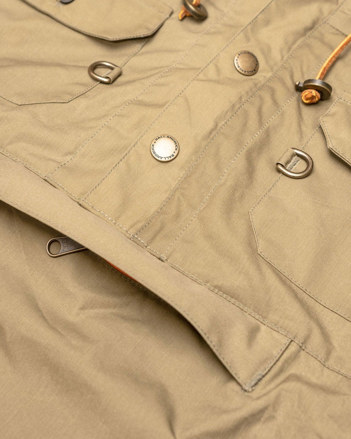 Brass snaps and D-rings on the front of the Waxed Cotton Anorak