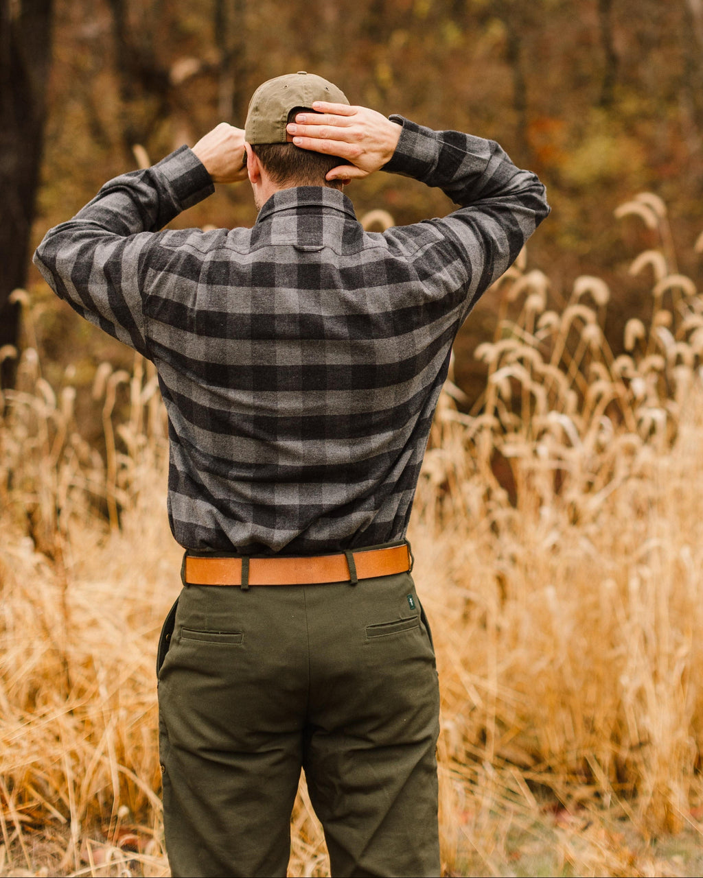 Back of the Grey Buffalo Plaid Sportsmans Shirt worn in a grass field