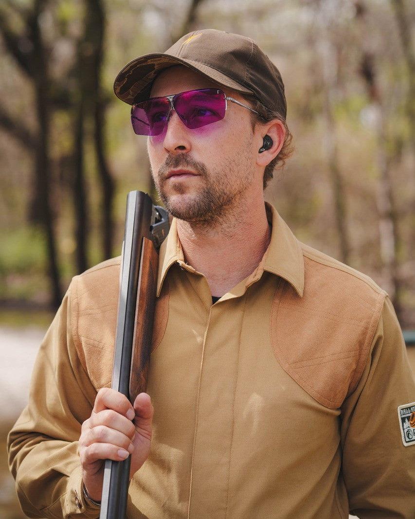 Shooter wearing Ranger glasses with purple lenses and holding a shotgun