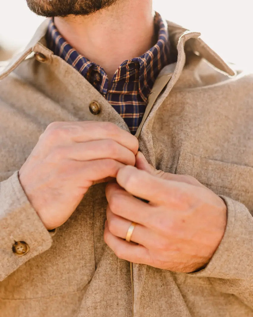 Close-up of hands buttoning the hidden placket on the Oatmeal Mariners Overshirt