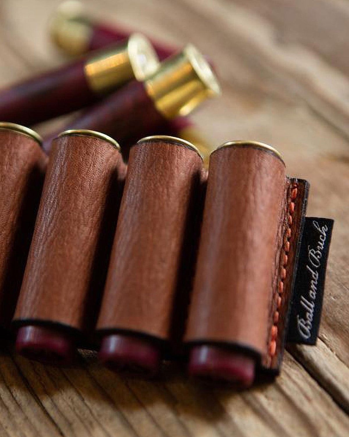 Versa Shell Holder Patch loaded with brass-head shotgun shells on a wood table