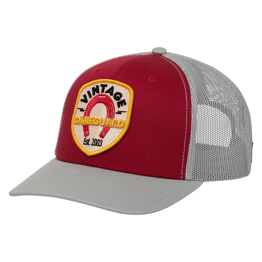 Red and gray trucker hat with Vintage Gameguard embroidered patch, ideal for hunting and outdoor use