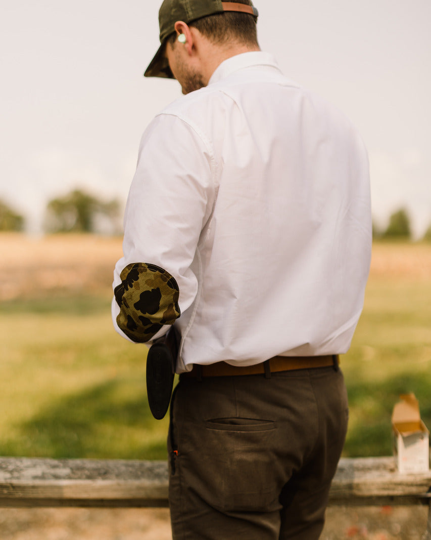 Back view of a shooter in the White Oxford Sportsmans Shirt with camo elbow patches