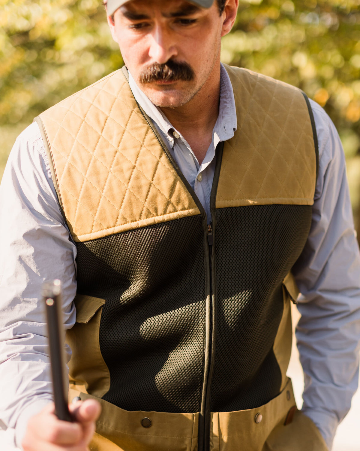 Man wearing the Heritage Clays Vest with quilted shoulder patches, front view