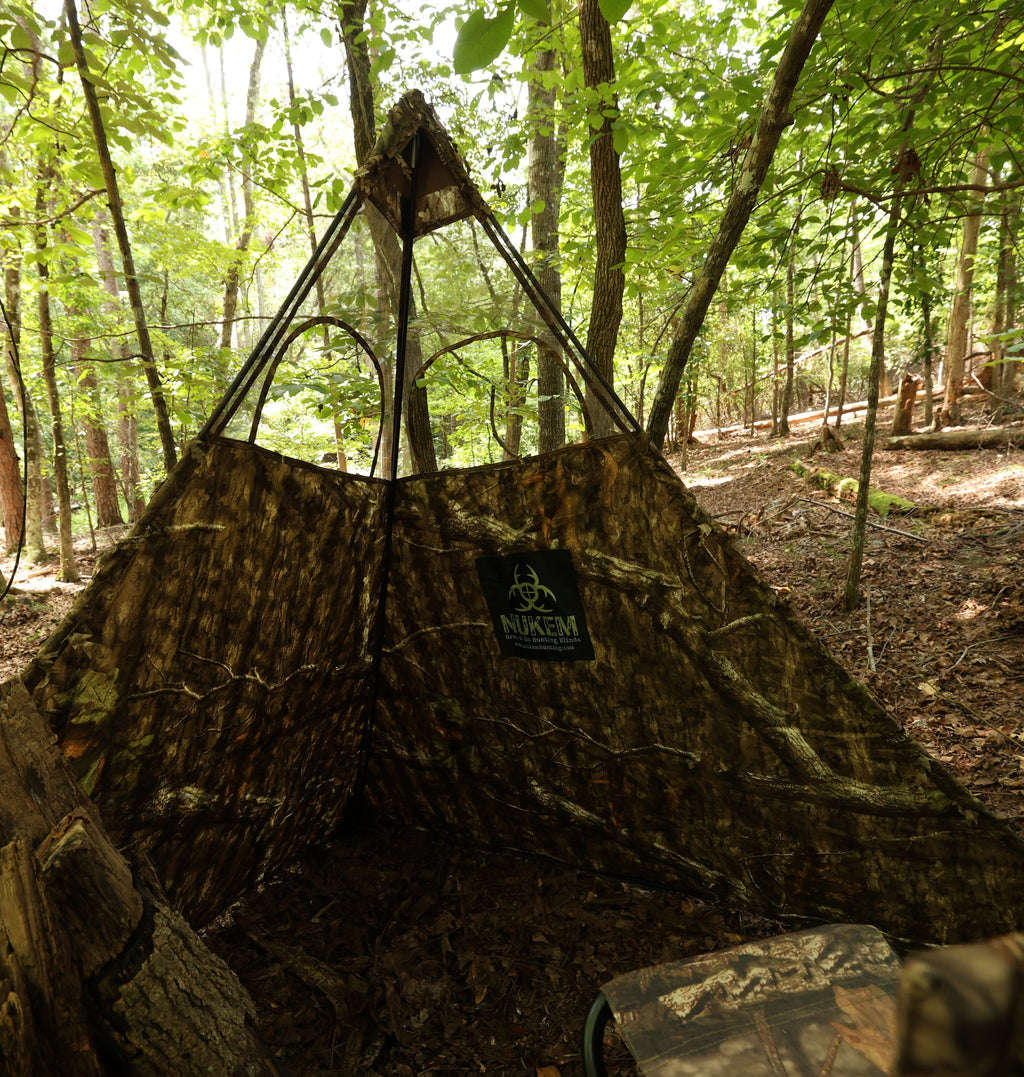 NUKEM camo hunting blind with tree bark pattern, set up in forest for deer hunting