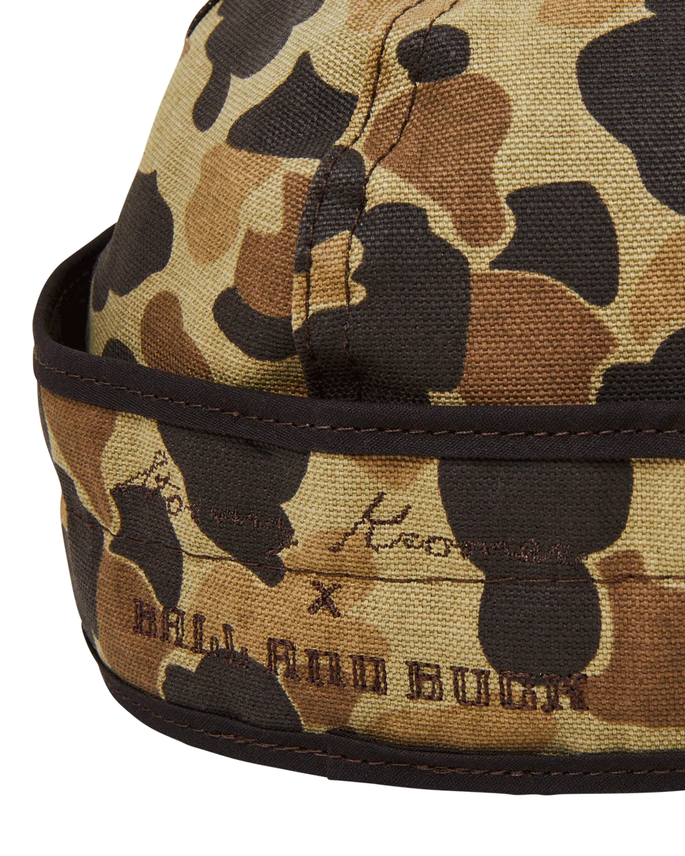 Back of the Original Camo insulated Stormy Kromer cap showing the ear band and embroidery