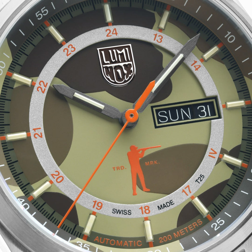 Close-up of the Luminox Original Camo dial with blaze orange hands and day-date window