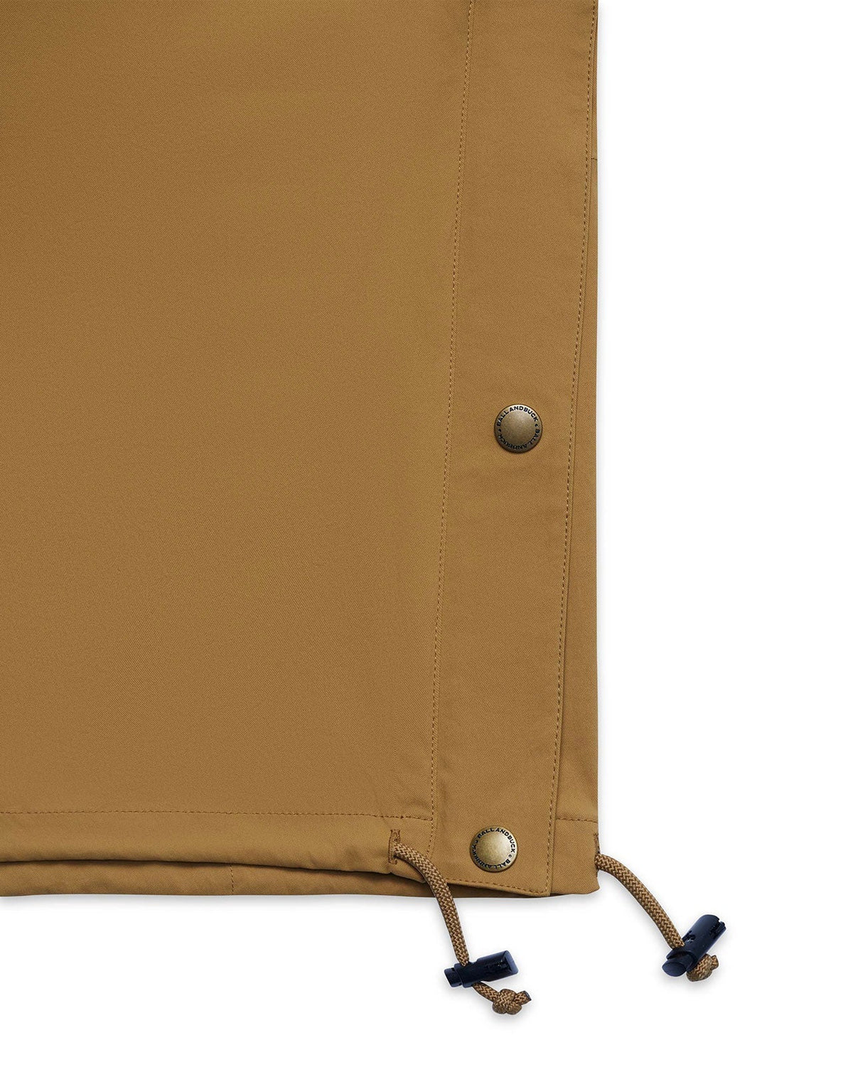 Waist drawstring toggle on the tan Active+ Anorak