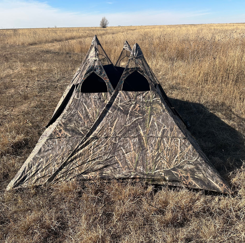 Camo hunting blind tent in dry field, ideal for turkey or deer hunting with concealment pattern