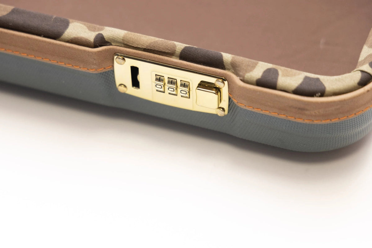 Polished brass combination lock on the Negrini x Ball and Buck shotgun case