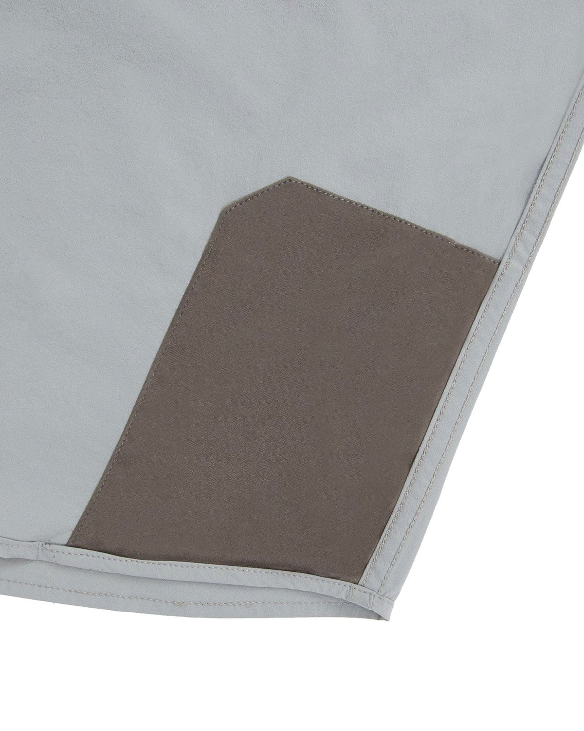 Microfiber lens cloth at the hem of the Stone Grey Active+ Guide Shirt