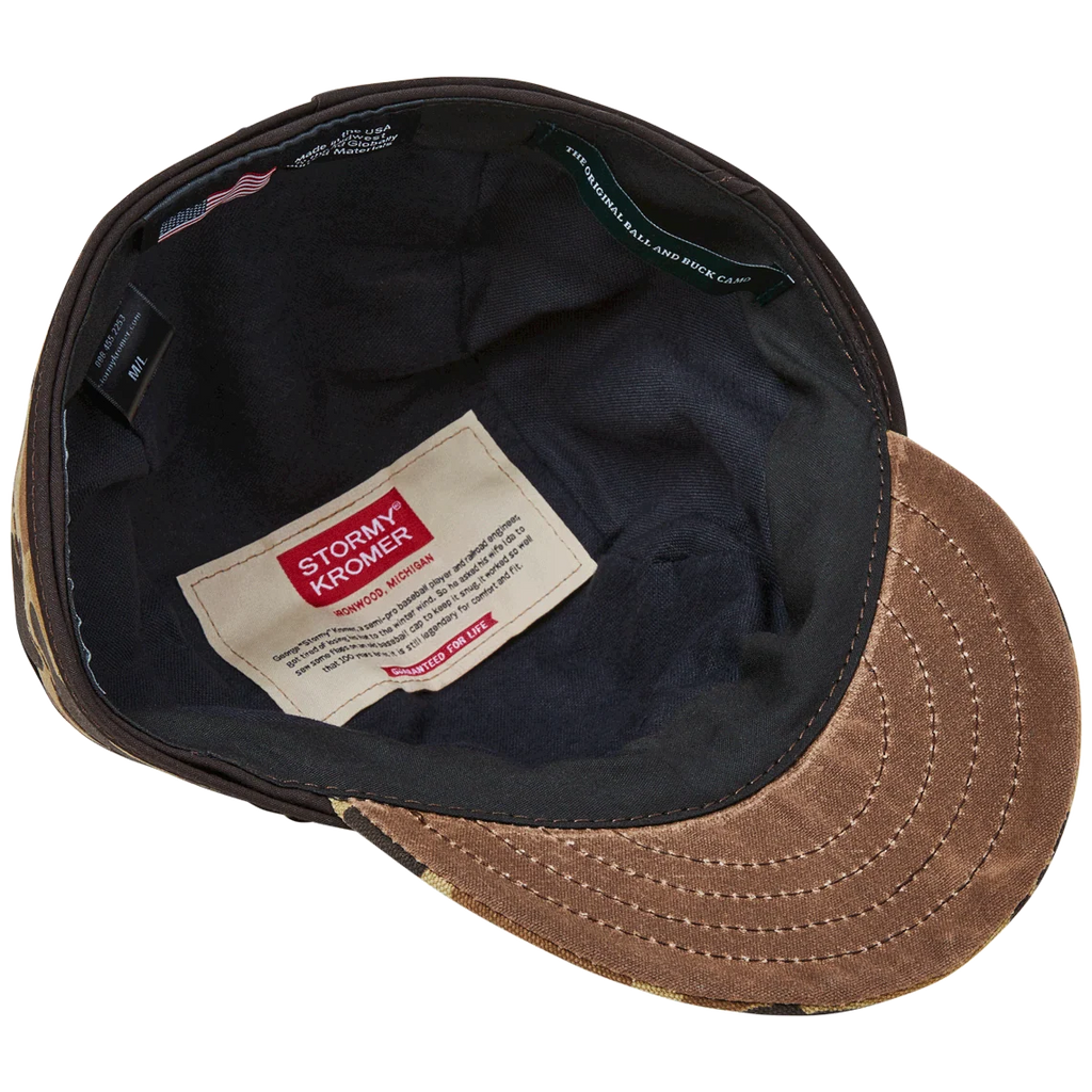 Underside of the Original Camo Stormy Kromer cap showing flannel lining and labels