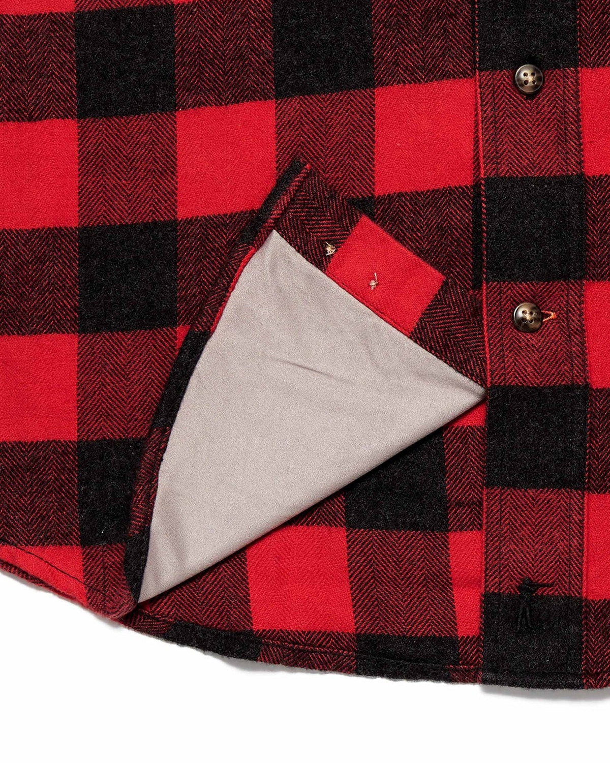 Microfiber sunglass cloth at the hem of the red Buffalo Plaid Sportsmans Shirt