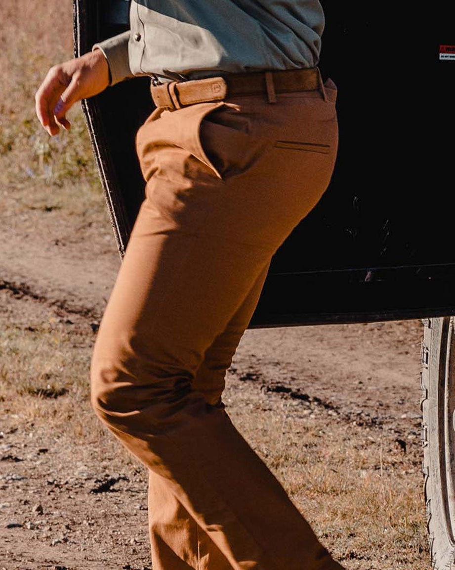 Heritage Pant in a tan duck canvas worn while walking on a dirt path