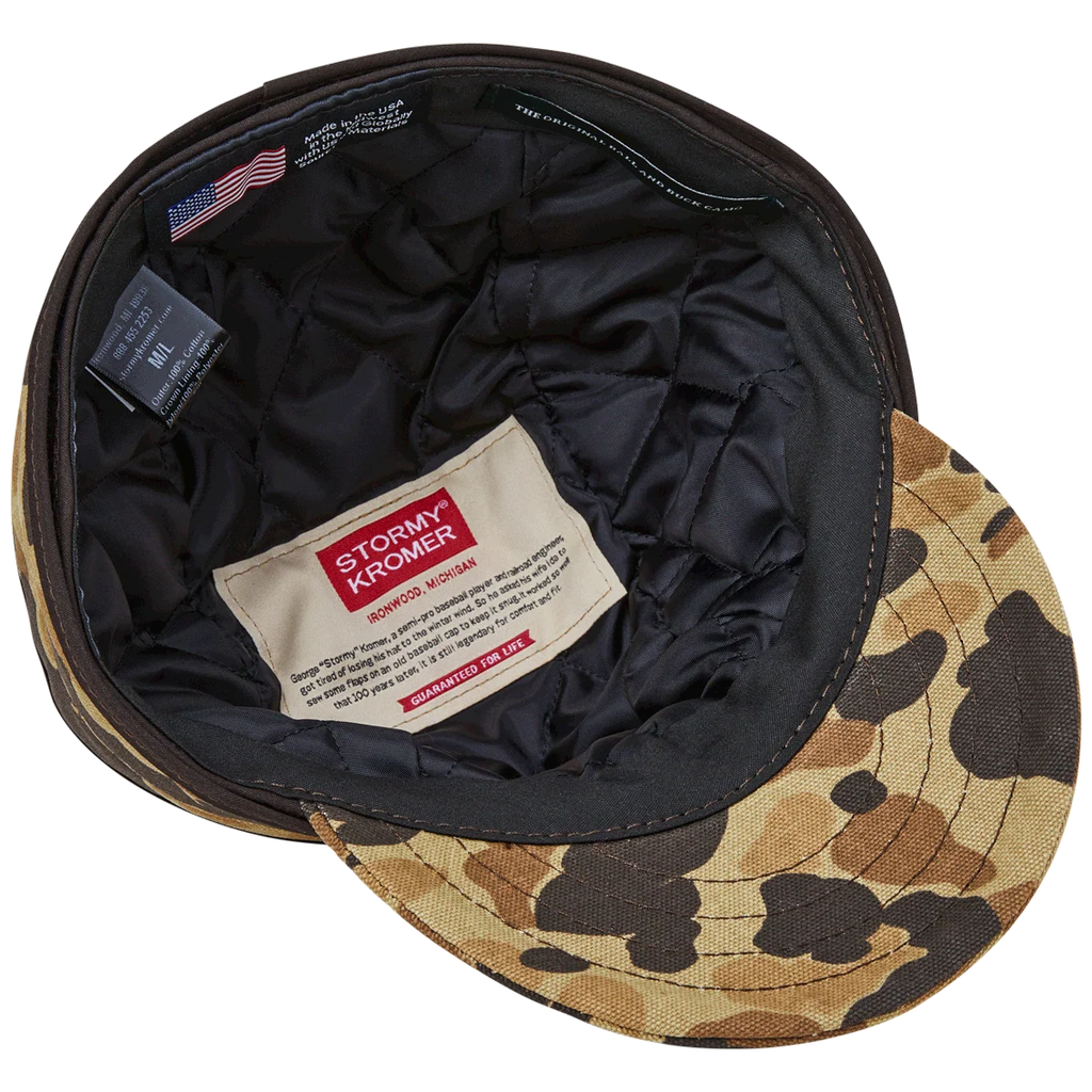 Underside of the insulated Stormy Kromer cap showing black quilted lining and labels
