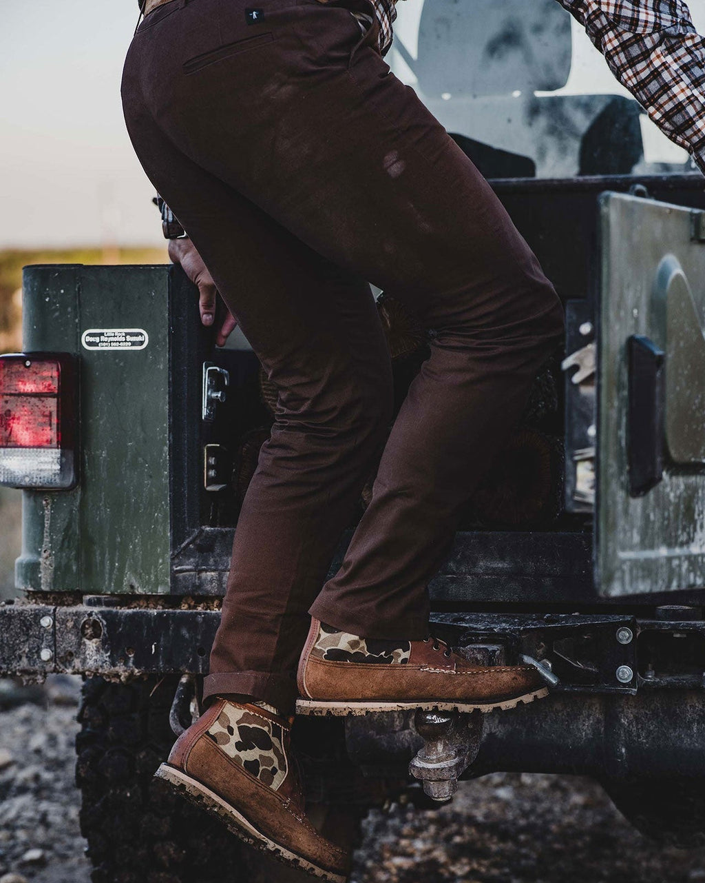 Man in the Bark Heritage Pant stepping out of a UTV