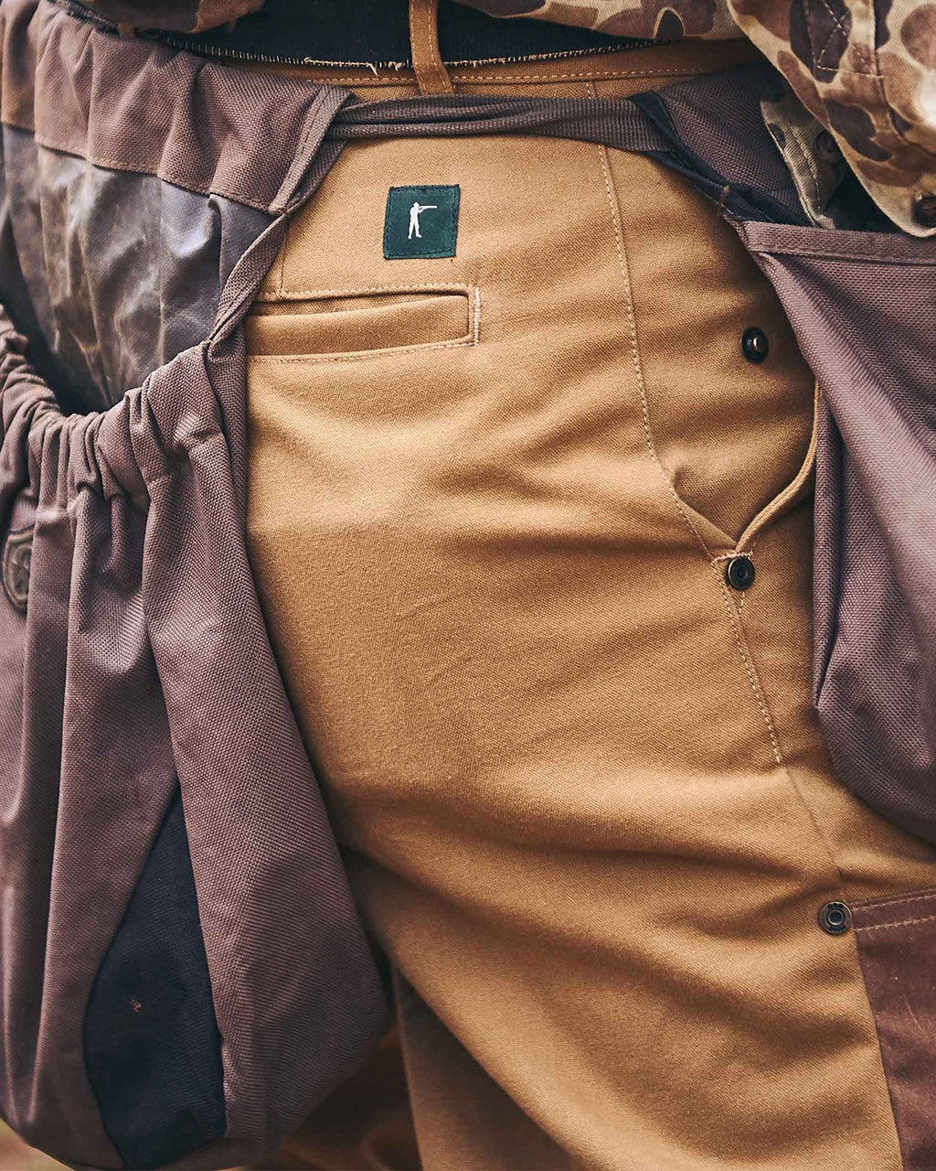 Original Field Pant worn with a waxed jacket, close-up of the front pocket and belt