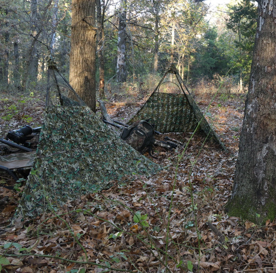 Camo hunting blind tent in forest, ideal for deer hunting and outdoor concealment with mesh windows