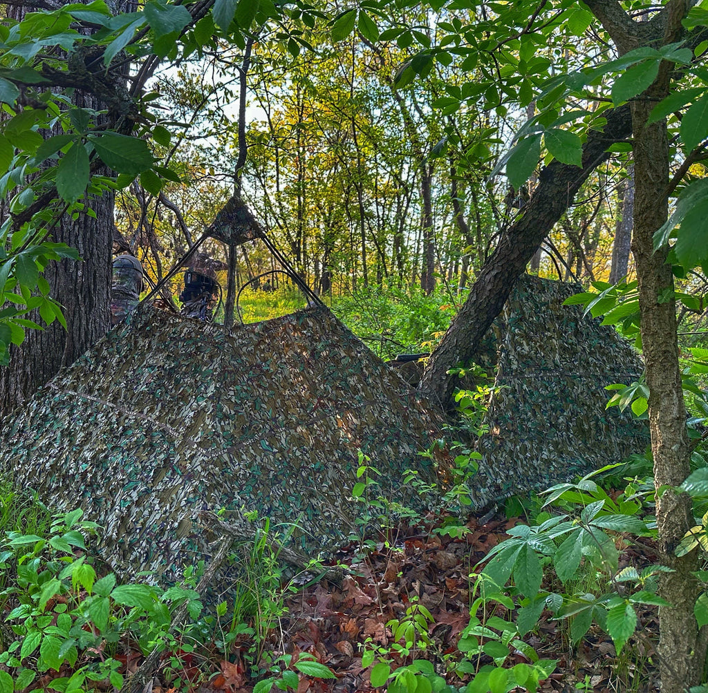 Camo hunting blind in forest, blending with trees for deer hunting concealment
