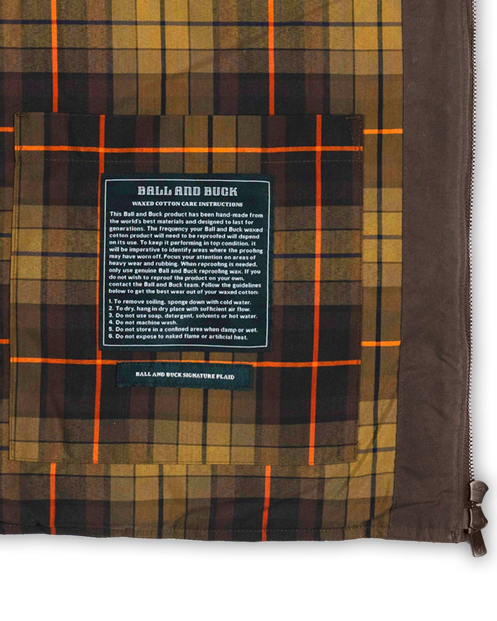 Interior stash pocket and label on the plaid lining of the Brown Arthur Down Vest