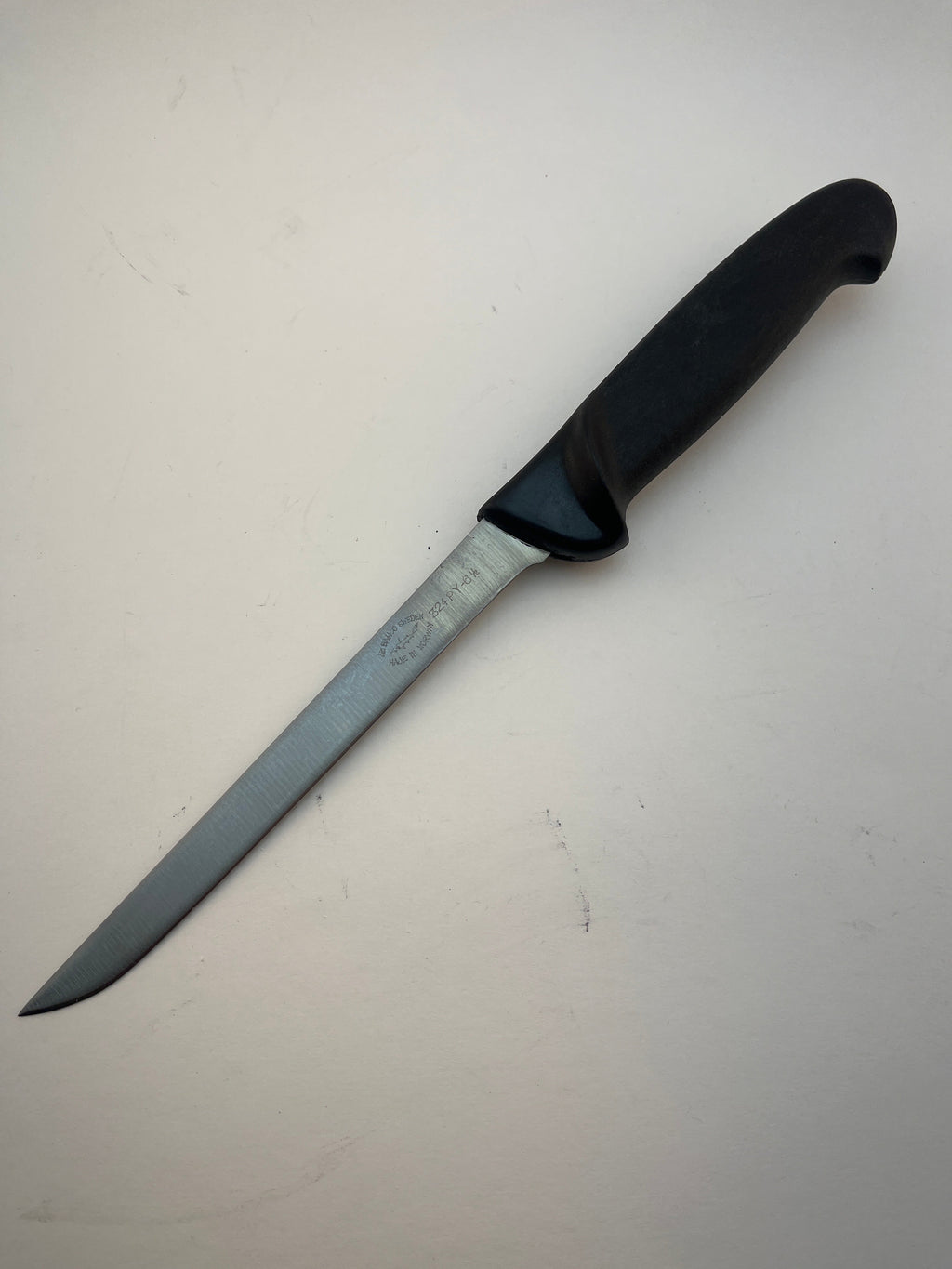 Black-handled hunting knife with stainless steel blade, ideal for outdoor and field use