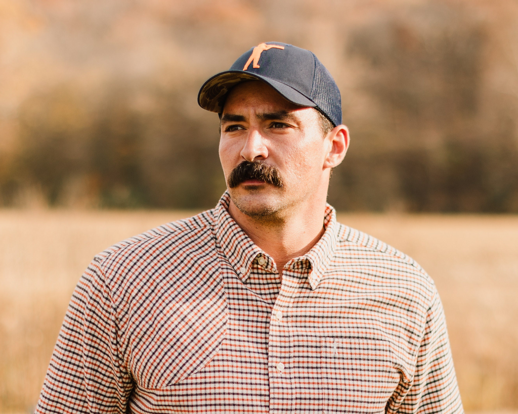 Navy Arthur Core Snapback worn outdoors, three-quarter view