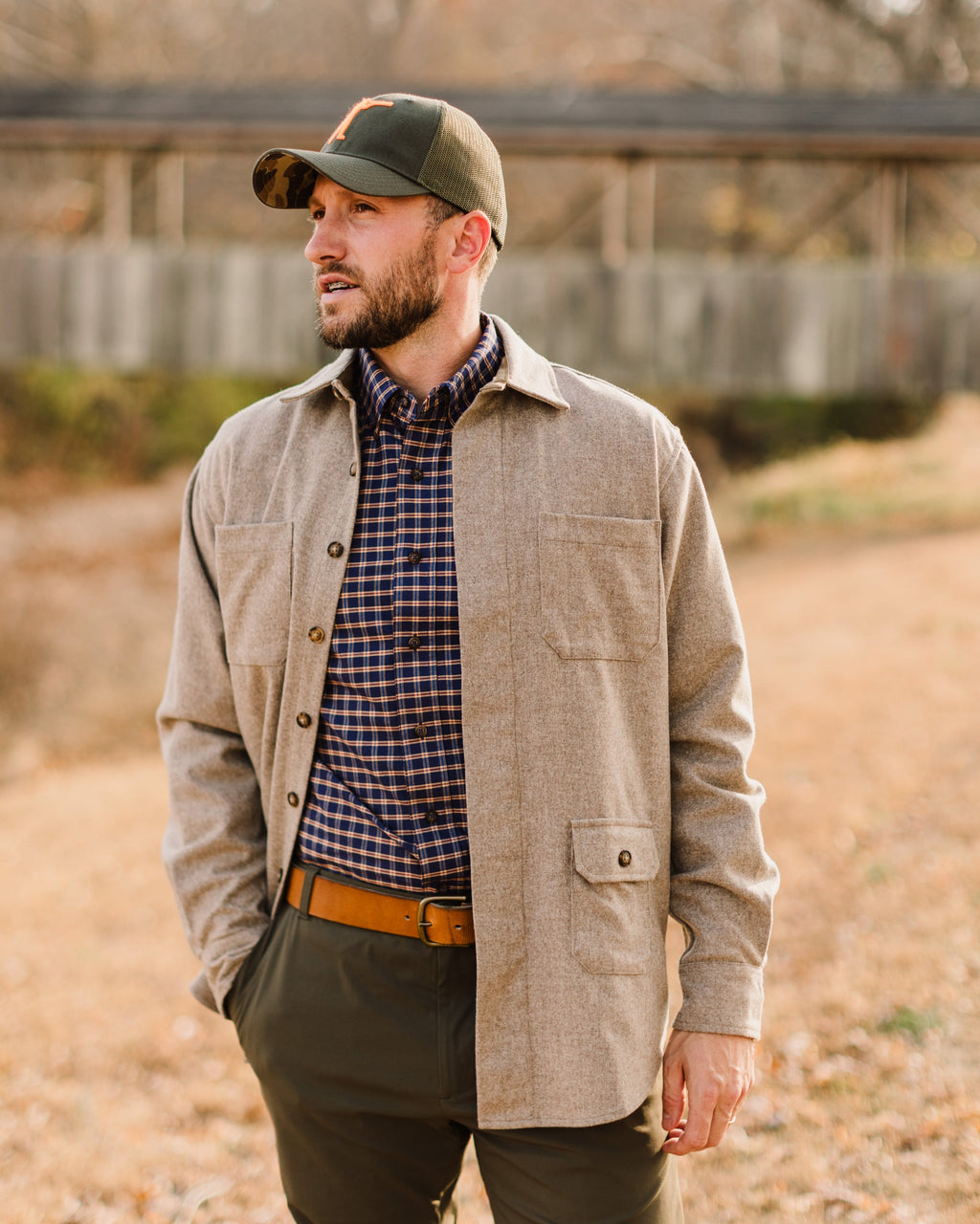 Olive Arthur Core Snapback worn with a tan jacket, side profile