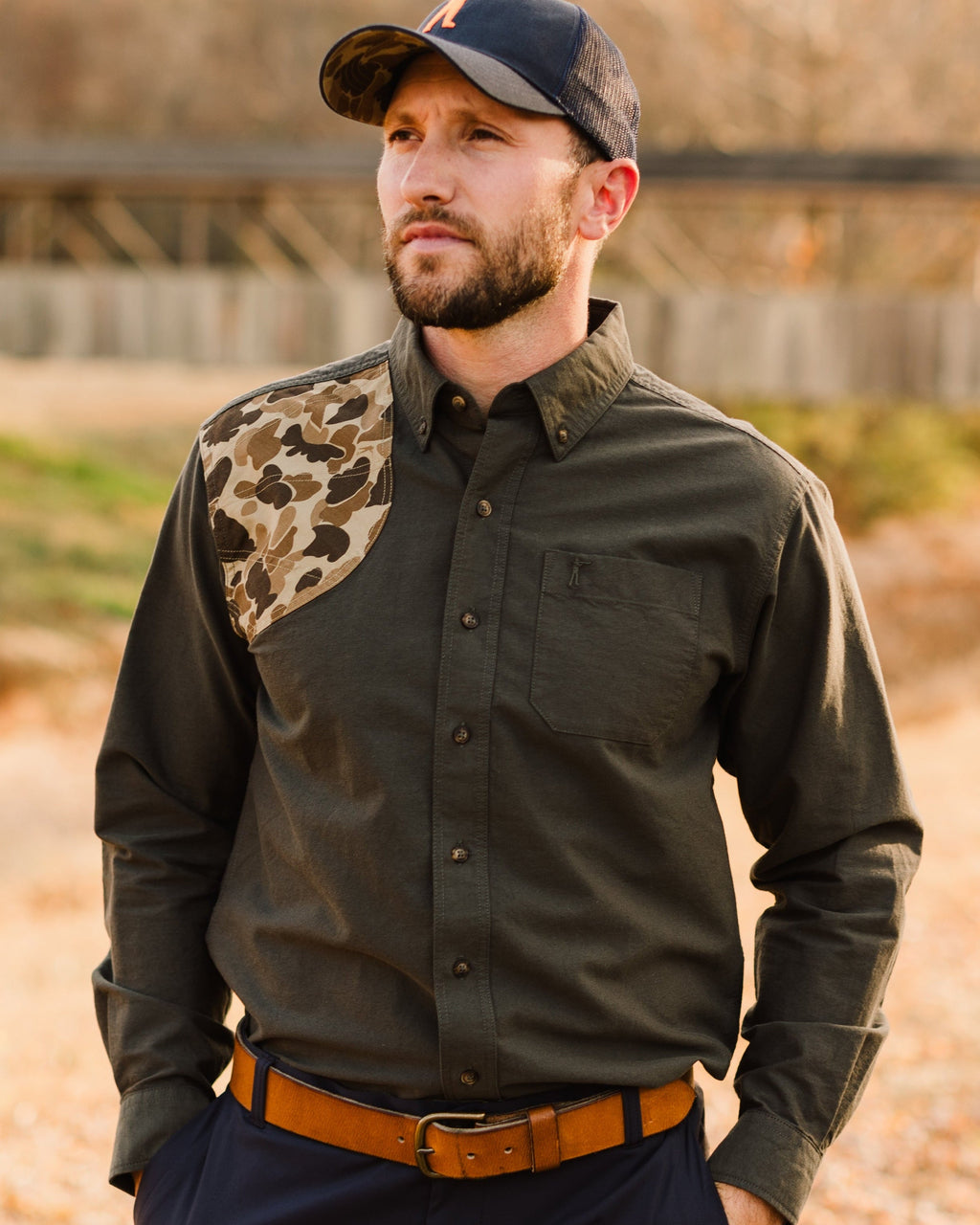 Man in the Moss Oxford Sportsmans Shirt and navy cap standing outdoors