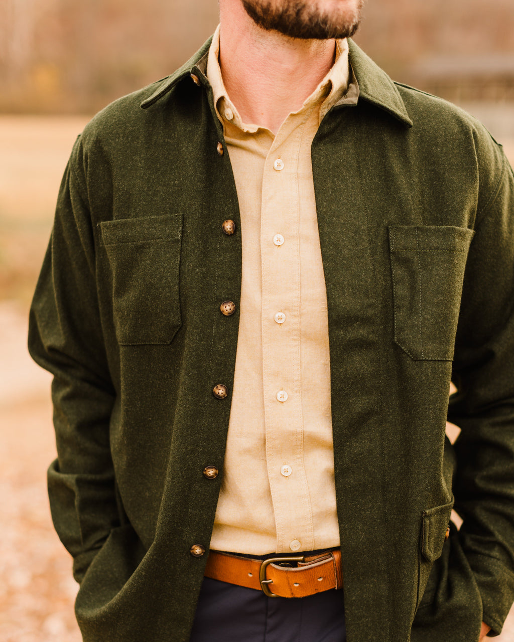 Loden Green Mariners Overshirt worn open over a tan button-down and leather belt