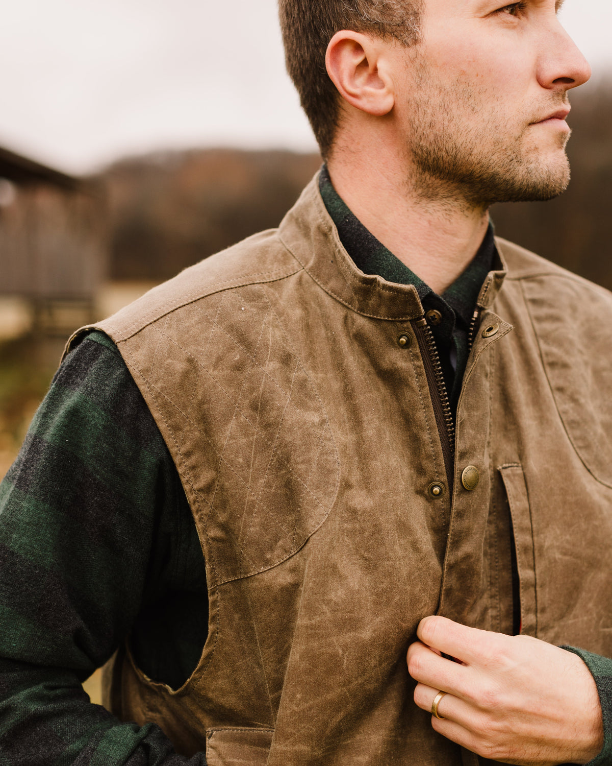 Close-up of a hunter opening the front of the Dark Oak Upland Vest