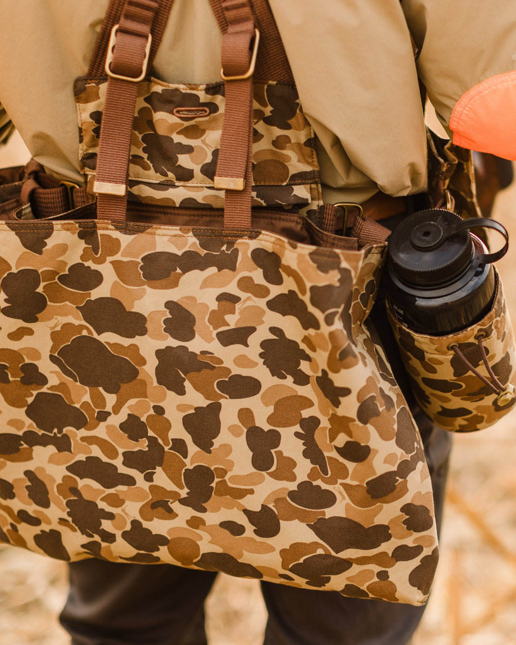 Original Camo Strap Vest worn from behind with a water bottle in the holder