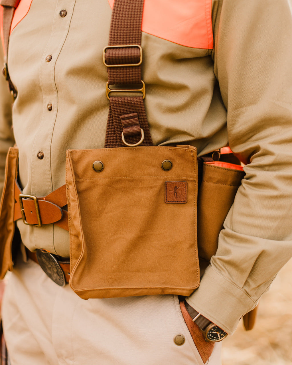 Front shell pocket and belt of the Signature Canvas Strap Vest worn over a khaki field shirt