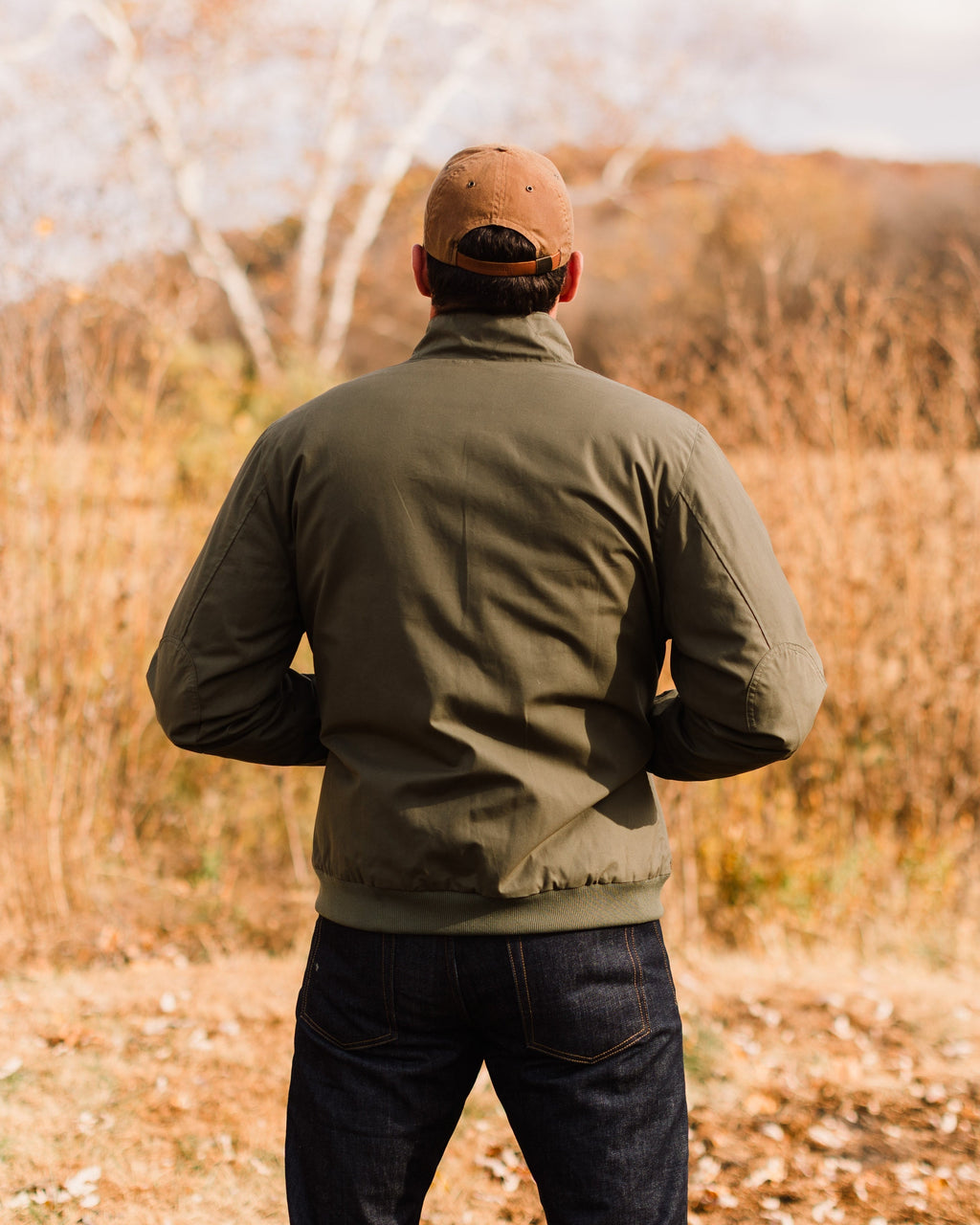 Back of the Sage Green Harrington Jacket worn outdoors